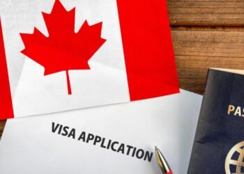 Visa application form, passport and flag of Canada