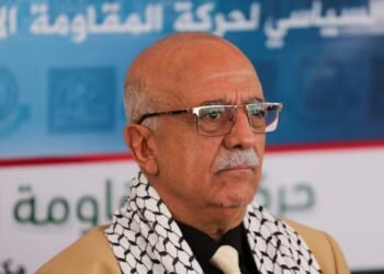 a man in glasses and a scarf