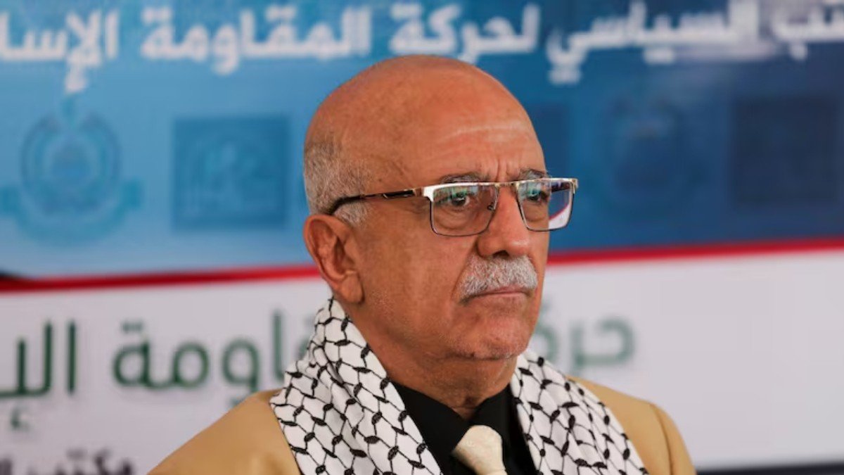 a man in glasses and a scarf