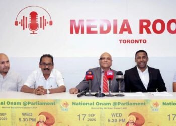 a group of men sitting at a table with microphones