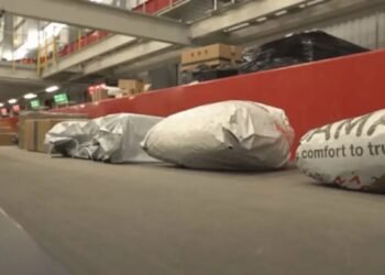 a group of bags on a conveyor belt