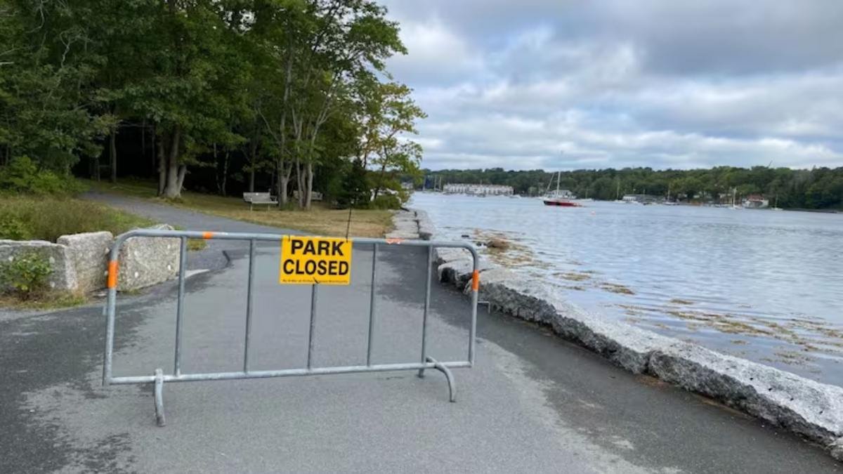 a metal fence with a yellow sign on it