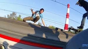 Youth jumps on top of moving train