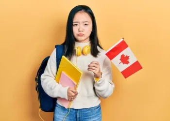 young-chinese-girl-holding canada flag
