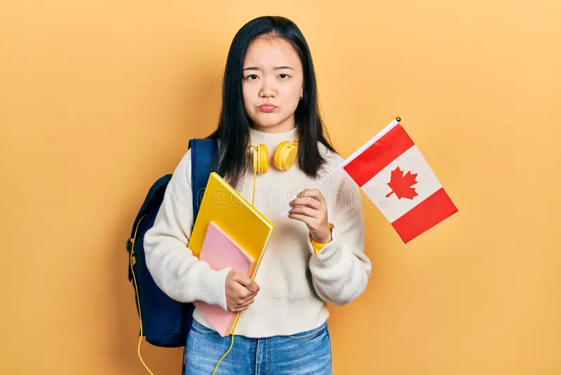 young-chinese-girl-holding canada flag