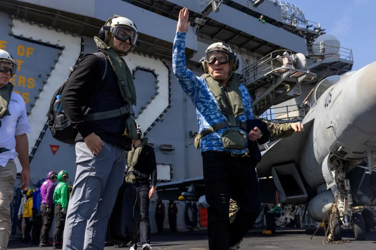 US Special Envoy to the Middle East Steve Witkoff waves on board aircraft carrier the USS Abraham Lincoln in the Arabian Sea