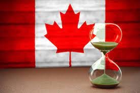 canada flag and sand clock