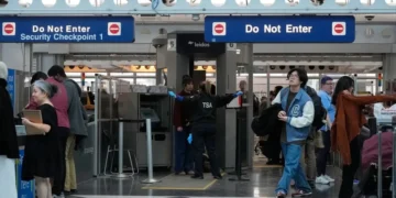 Travellers go through TSA security check at O'Hare International Airport, Saturday, March 21, 2026, in Chicago. (AP Photo/Kiichiro Sat0)