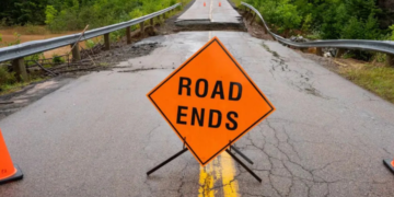 Warning signage is seen in front of a washed out road near Marble Mountain