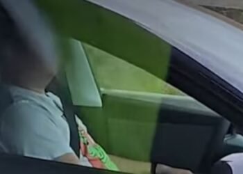 The BCHP says an officer passed a sleeping driver in a dark-coloured Tesla on Aug. 27 as it sped down the Trans-Canada Highway through Langley. (RCMP)