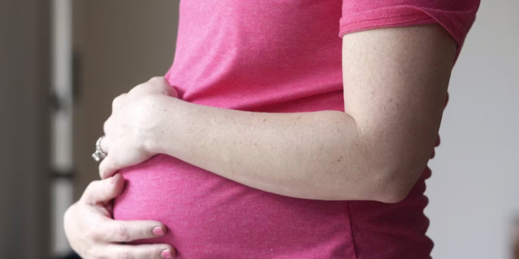 A pregnant woman touches her belly on May 18, 2023, in Dallas, Texas. (AP-LM Otero)