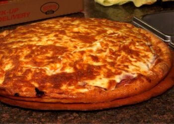 A Houston Pizza employee prepares a Regina-style pizza. (Allison Bamford/CTV News)